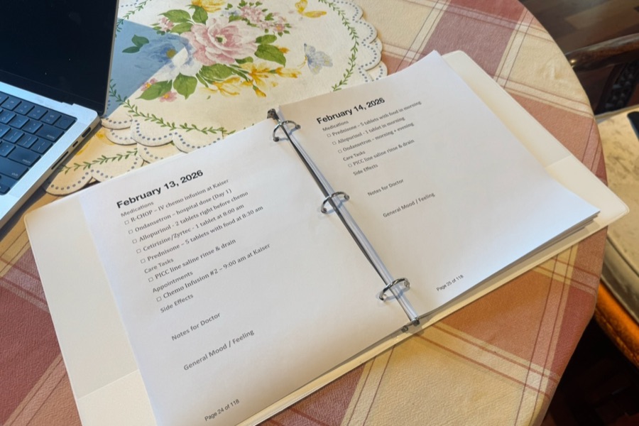 A printed caregiving binder on a table